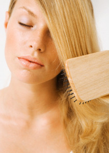 Blond Woman Brushing Her Hair